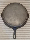 Early Griswold Cast Iron No. 12 Slant Italic Erie 719 Skillet W/ Smoke Ring Used. Price: $575.00.
