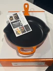 New - Creuset Signature Cast Iron 9 Inch Skillet, Flame. Price: $139.99.