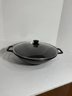 Lodge P14W Cast Iron 14.5" Wok With Lid Flat Bottom Loop Handles Made In Usa Used. Price: $74.95.