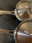 2 Calphalon Anodized Commercial Aluminum Sauce Pans & Covers Used. Price: $46.00.