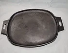 Pampered Chef 10" X 16" Cast Iron Sizzle Skillet- Item #100369 Used. Price: $29.99.