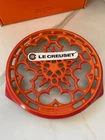 Le Creuset Volcanic Flame Round Trivet Cast Iron New/original Box. Price: $125.00.