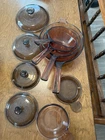 Vintage Visions Corningware Amber Glass Pots & Pans Set With Matching Lids Used. Price: $110.00.