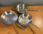 Emeril By All Clad 4 Pieces Stainless Steel Pot W/ Lid; 8 & 10 In. Sauce Pans Used. Price: $139.82.
