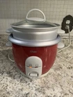 Oster 6-CUP Rice Cooker With Steamer, Red (004722-000-000) Used. Price: $16.87.
