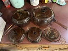 Vintage Visions Corningware Amber Glass Pots & Pans Set With Matching Lids Used. Price: $80.00.