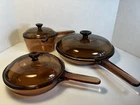 Set 3 Vtg Visions Corningware Pyrex Amber Glass Cookware Pot Pans Lids 6 France Used. Price: $88.88.