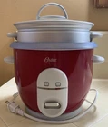 Oster 6-CUP Rice Cooker With Steamer, Red (004722-000-000) Used. Price: $22.99.