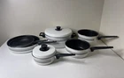 Vintage 7 Piece Set Of Mirro Cast Aluminum Pots & Pans Almond Cream Stripe Used. Price: $69.95.